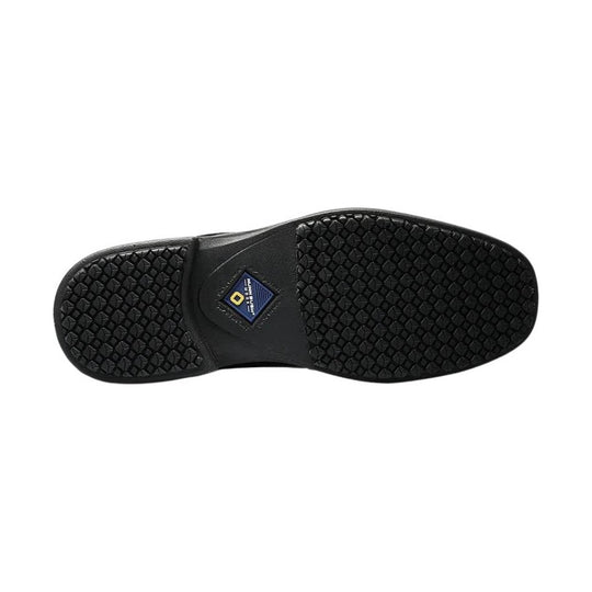 Black rubber shoe outsole shown from below with textured tread and a small center logo patch
