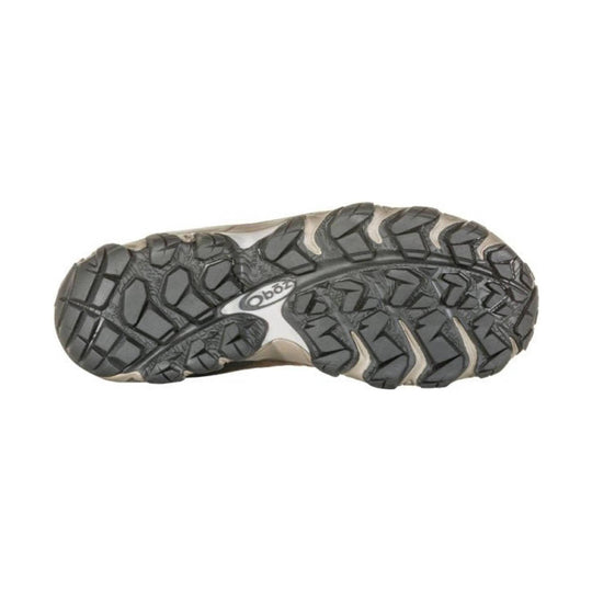 Traction outsole of a hiking shoe with deep lug tread and Oboz logo