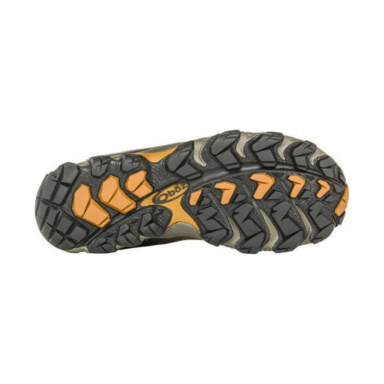 Sole of a black and orange hiking boot with deep lug tread and Oboz logo