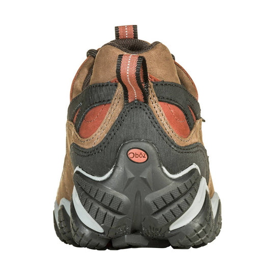 Rear view of a low hiking shoe in brown, tan, and dark gray with a black lugged sole and coral pull tab