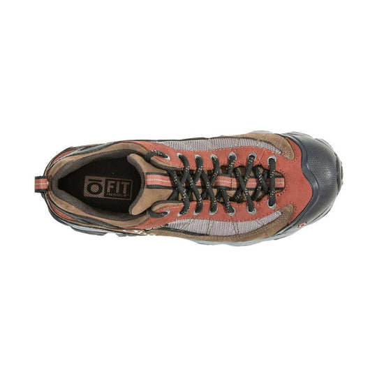 Low hiking shoe in rust, tan, and gray with black laces and a rubber toe cap, shown from above