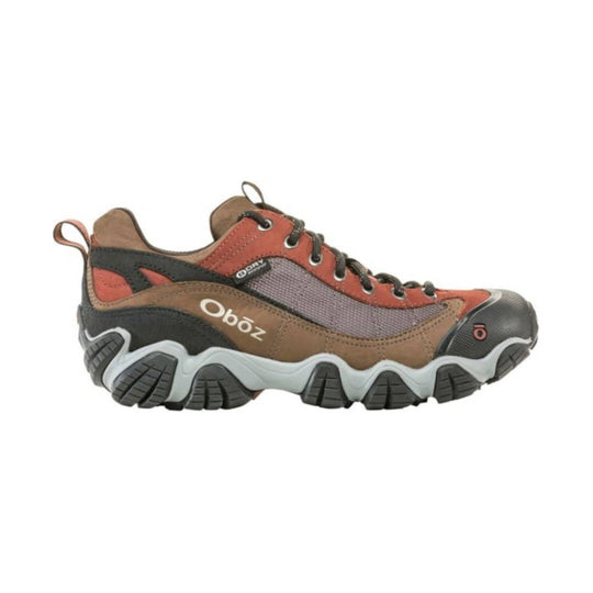 Brown and rust low-top hiking shoe with mesh panels, black laces, and a rugged lug sole