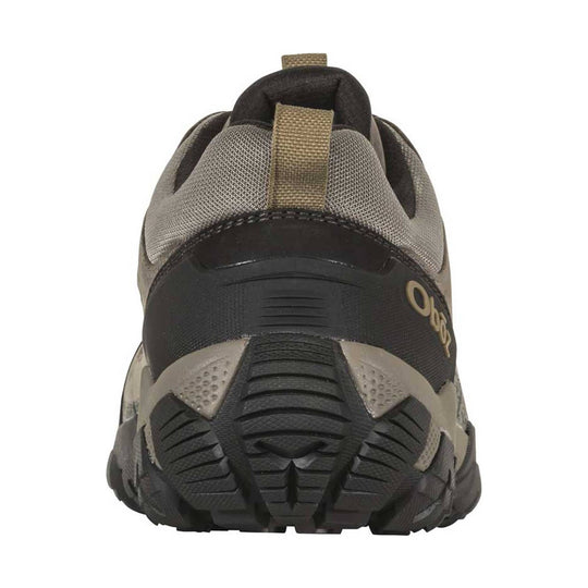 Rear view of a gray and black hiking shoe with tan pull tabs and rugged tread