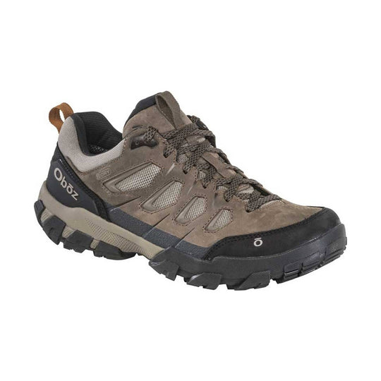 Brown low-top hiking shoe with black sole, mesh panels, and lace-up closure
