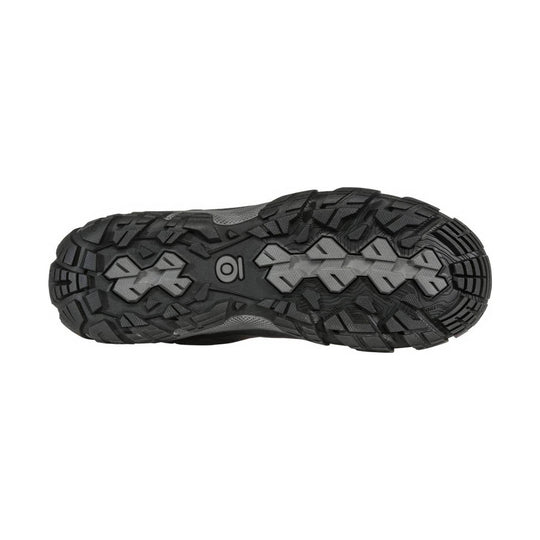 Black rugged hiking shoe outsole with deep tread and gray traction inserts