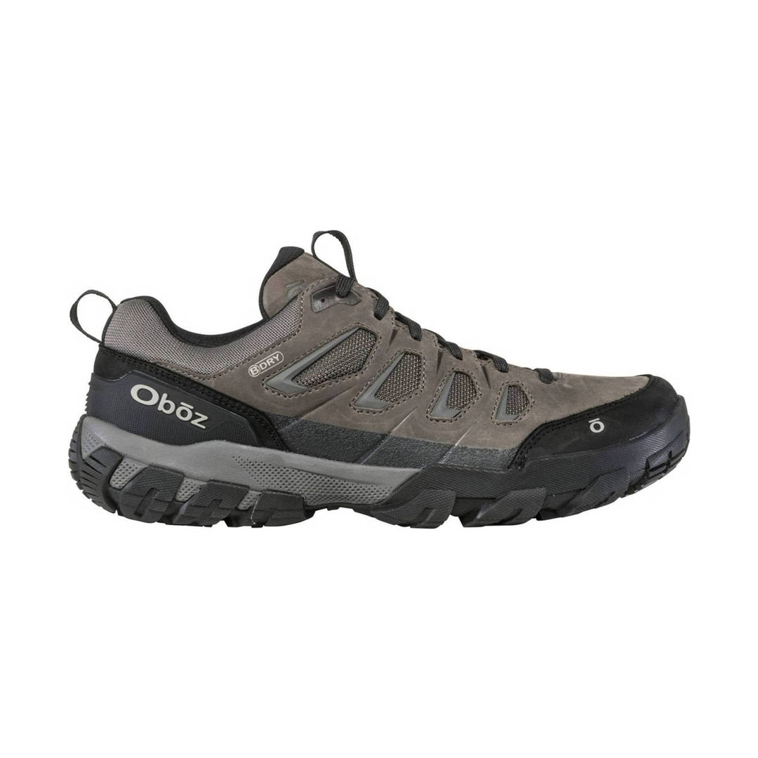 Gray low-top hiking shoe with black outsole, mesh side panels, and trail lugs