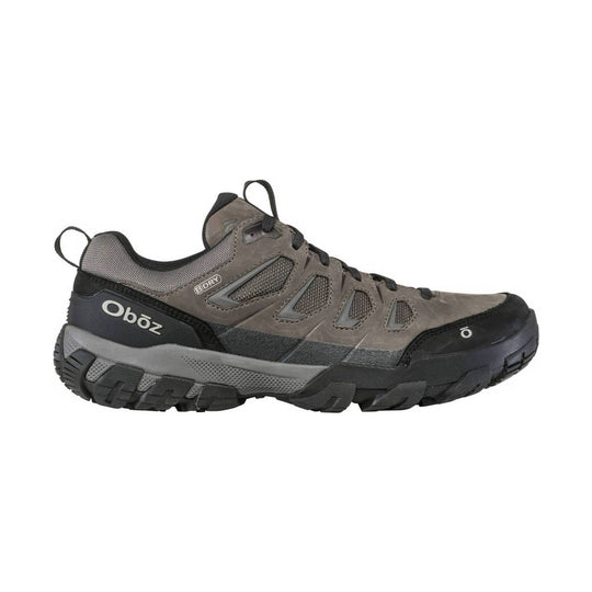 Gray low-top hiking shoe with black outsole, mesh side panels, and trail lugs