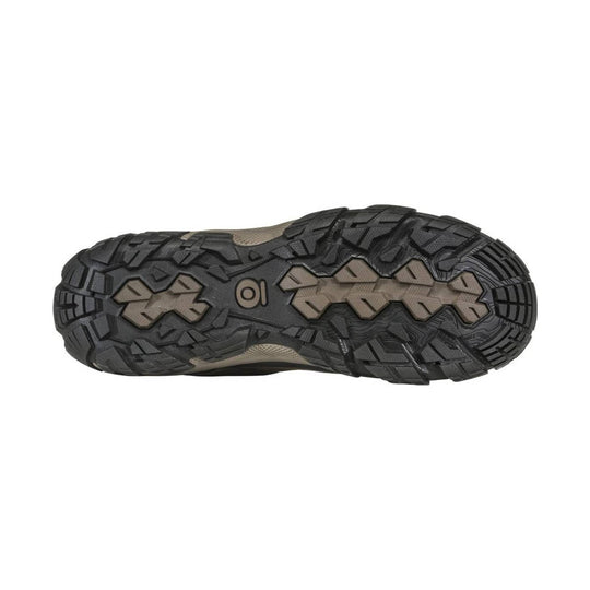 Black and tan hiking boot outsole with rugged multi-directional tread