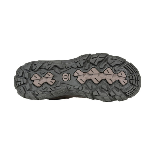 Gray hiking boot outsole with deep tread and beige traction inserts