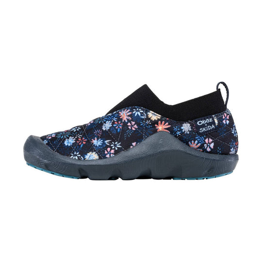 Black slip-on shoe with multicolor floral quilted upper, gray sole, and heel pull tab