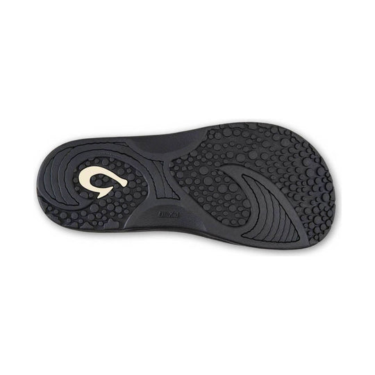 Black rubber sandal outsole with circular tread and OluKai logo