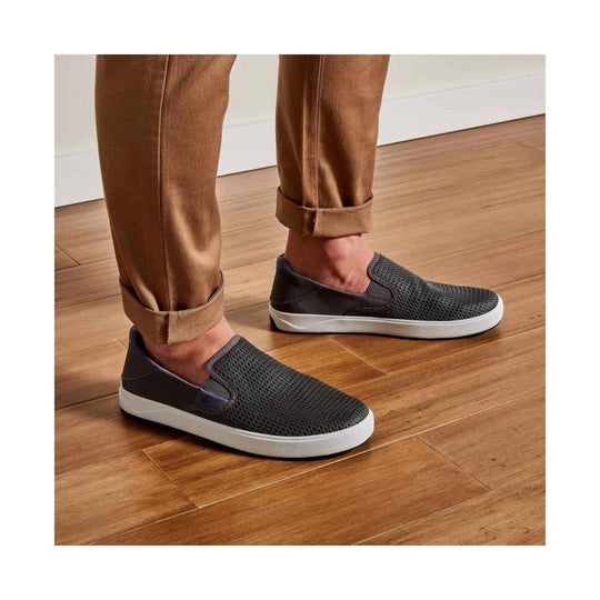 Dark gray knit slip-on shoes with white soles, worn with rolled tan pants
