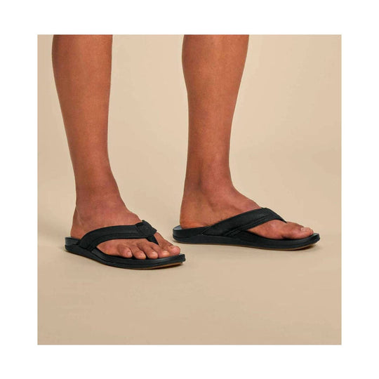 Black thong-style flip-flops with wide straps and flat soles