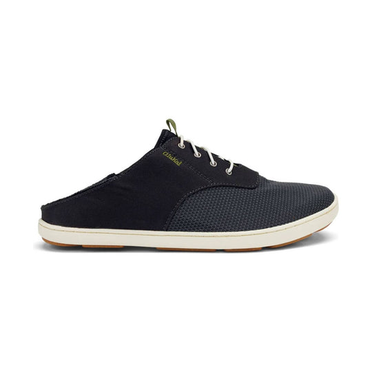 Black slip-on shoe with white laces, olive heel pull tab, and cream sole