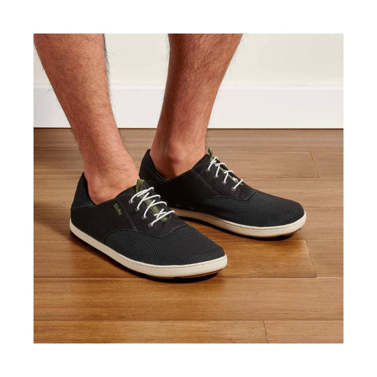 Black low-top casual shoes with white soles and white laces