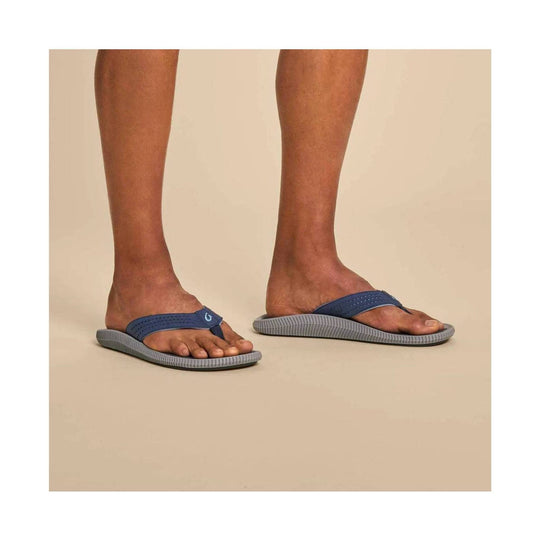 Blue thong flip flops with gray soles shown on a model's feet
