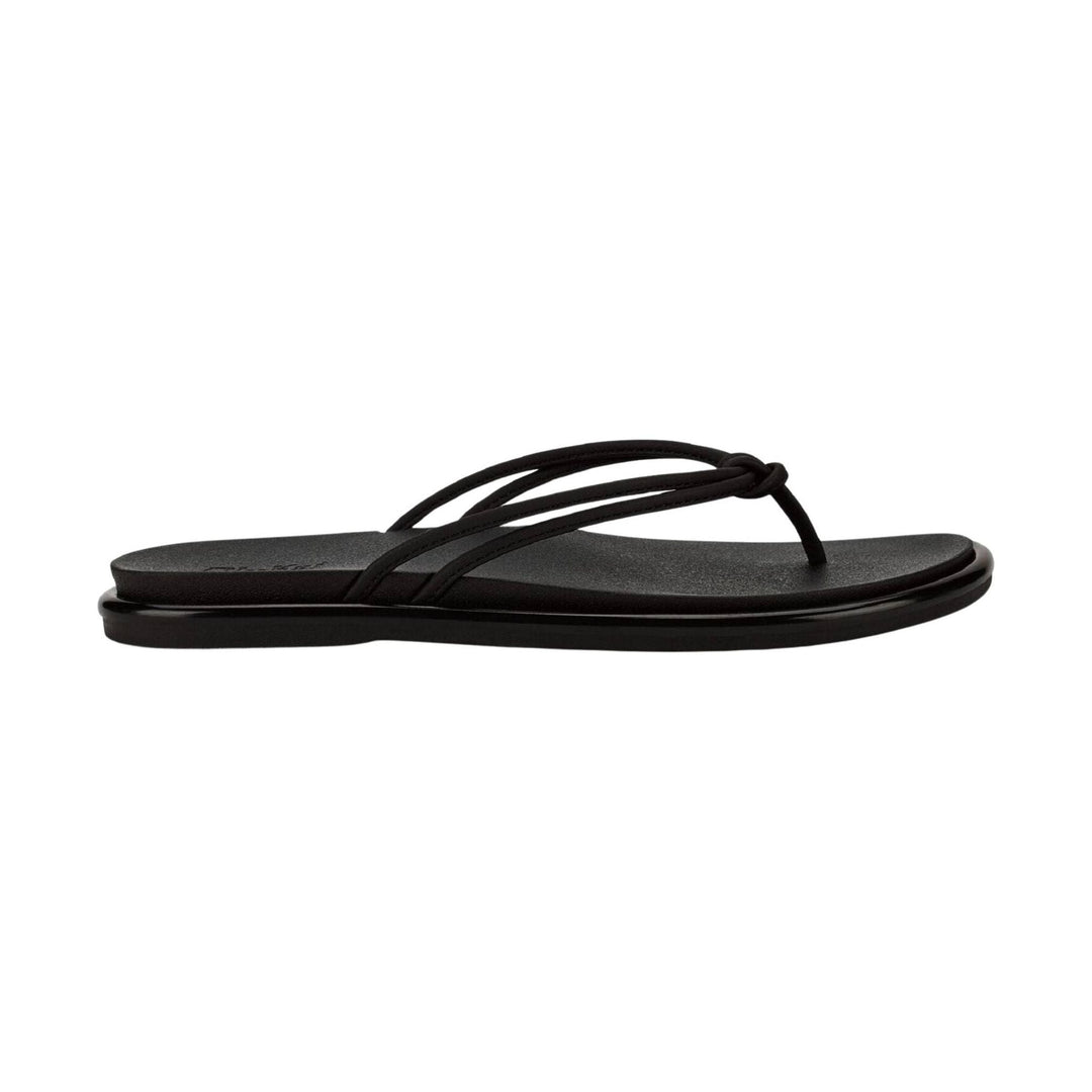 Black thong sandal with slim braided straps and a flat sole, shown in side view