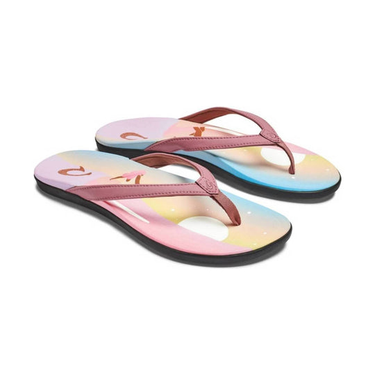 Pastel pink thong flip-flops with floral-patterned footbeds and black soles