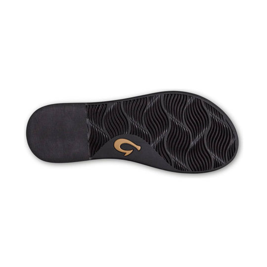 Black sandal outsole with wavy tread and a gold logo near the arch