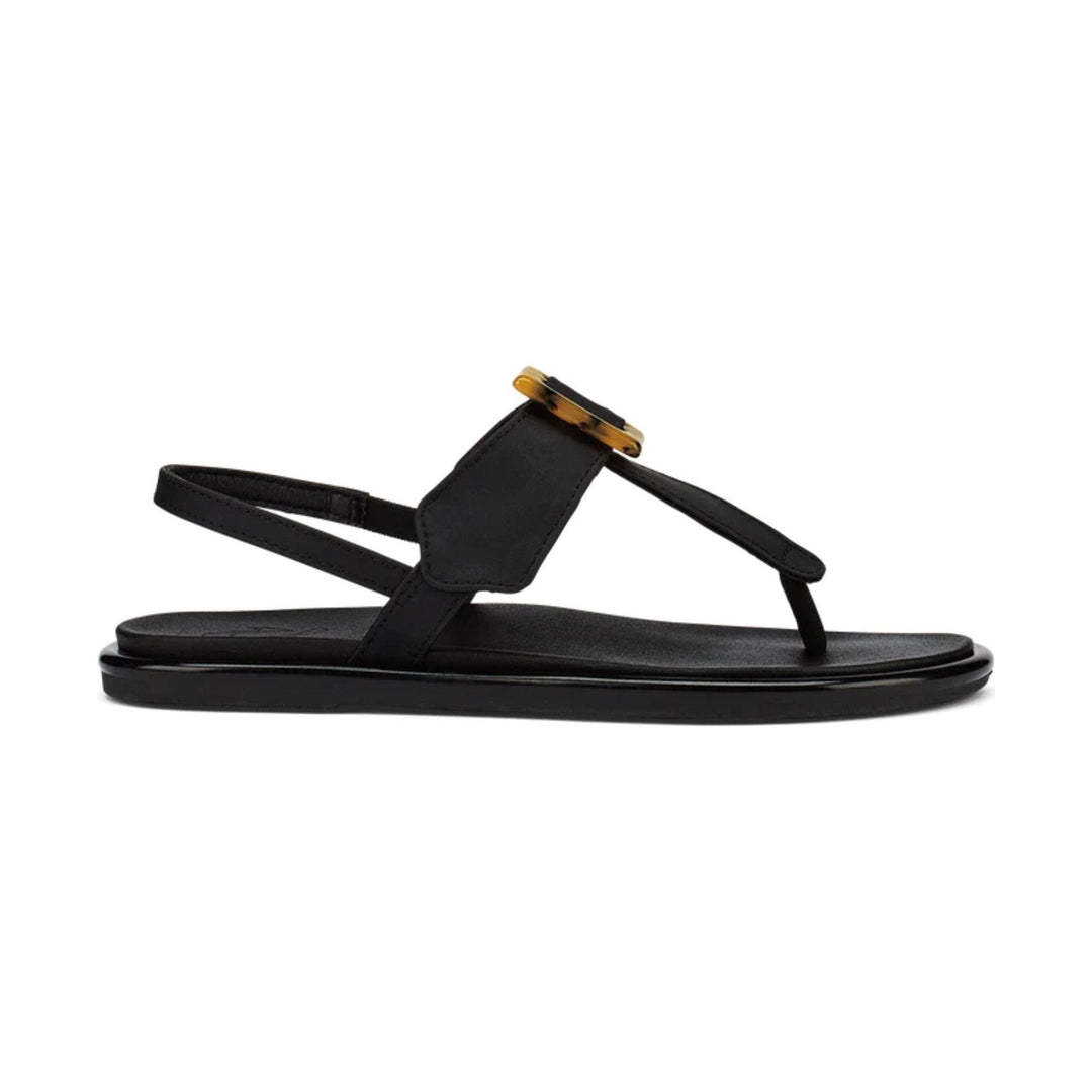 Black flat-strap sandal with a gold buckle detail and thick sole, side view