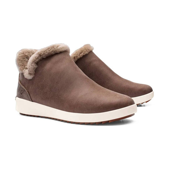 Brown suede ankle boots with cream shearling cuffs and thick white soles
