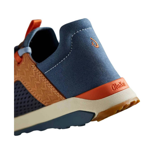 Blue and tan slip-on shoe with orange heel tab and embossed Olukai heel branding
