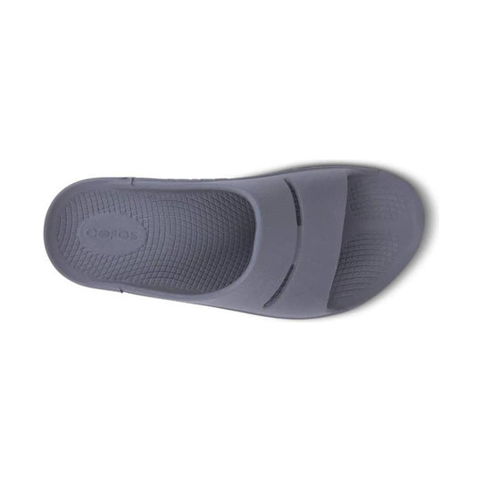 Gray foam slide sandal with a textured footbed and embossed logo