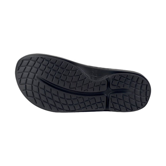 Black slide sandal sole with textured tread pattern