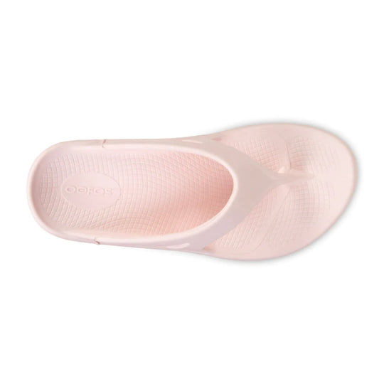 Light pink flip-flop sandal with textured footbed and embossed logo