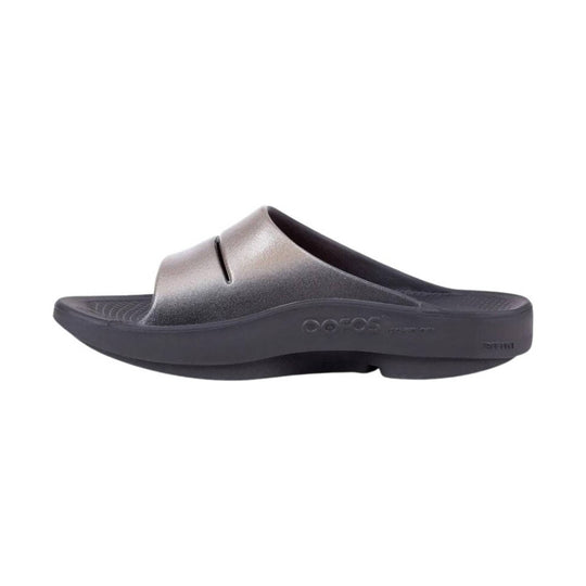 Black slip-on recovery slide sandal with a contoured footbed and embossed side logo