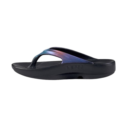 Black thong flip-flop sandal with iridescent purple-blue strap and thick wedge sole