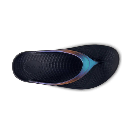 Black thong sandal with iridescent blue and purple strap and textured footbed