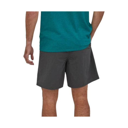 Dark gray athletic shorts worn with a teal shirt, shown from the back