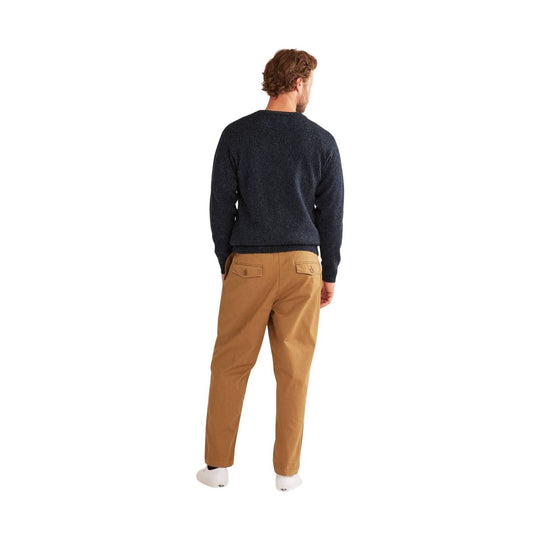 Back view of a dark crewneck sweater with tan straight-leg pants and white socks