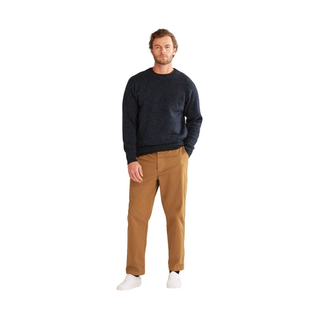 Dark crewneck sweater with long sleeves, tan straight-leg pants, and white sneakers