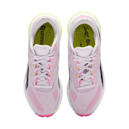 Pair of white mesh running shoes with pink accents and neon yellow insoles, top view