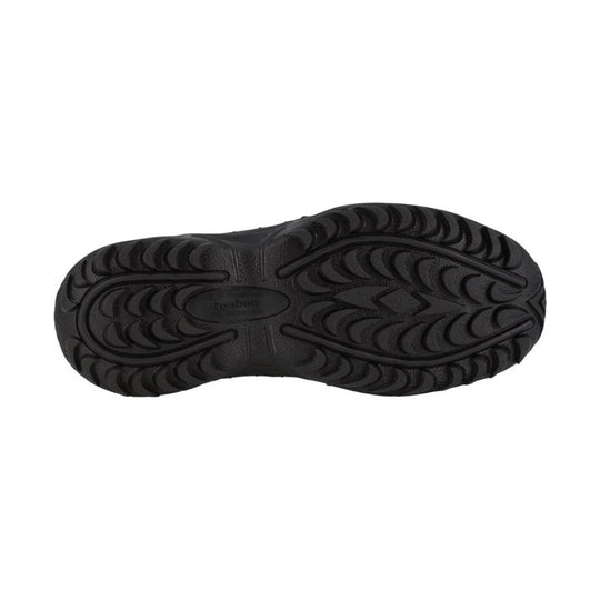Black shoe outsole with curved tread pattern and molded traction channels