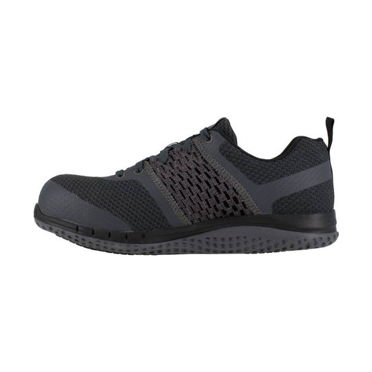 Dark gray and black work shoe with knit upper, laces, and a textured sole, shown in side profile