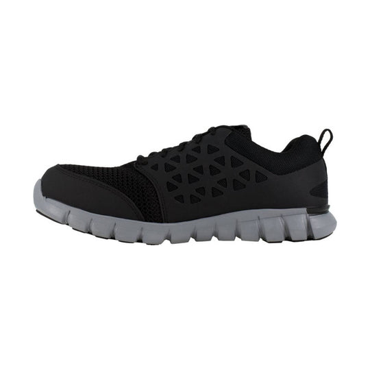 Black low-top work shoe with mesh upper, triangular side cutouts, and a gray cushioned sole