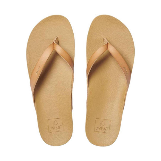 Pair of beige thong flip-flops with textured footbeds and embossed Reef logos