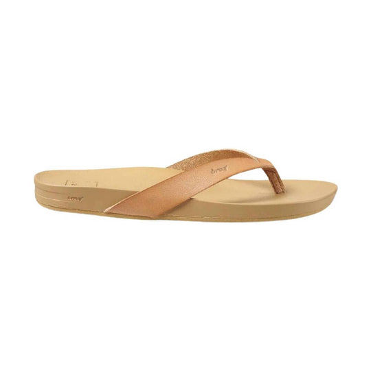 Beige thong sandal with a metallic rose-gold strap and platform sole