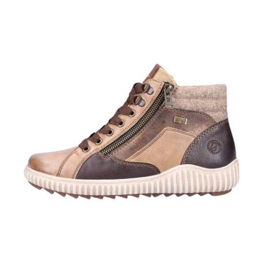 Tan and brown leather ankle boot with side zipper, laces, and a ribbed off-white sole