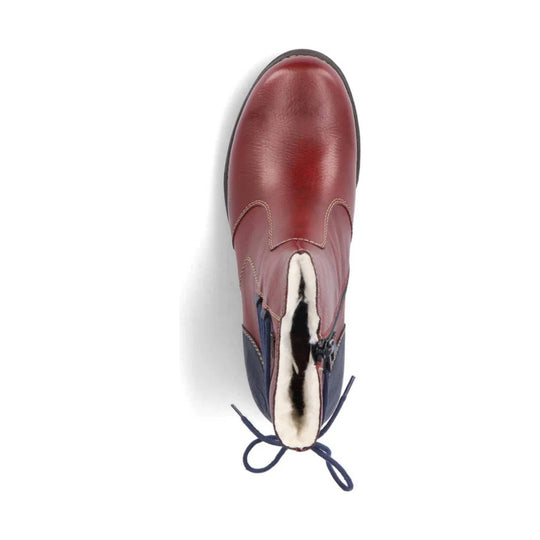 Burgundy leather ankle boot with side zipper, white faux fur lining, and dark blue heel pull loops