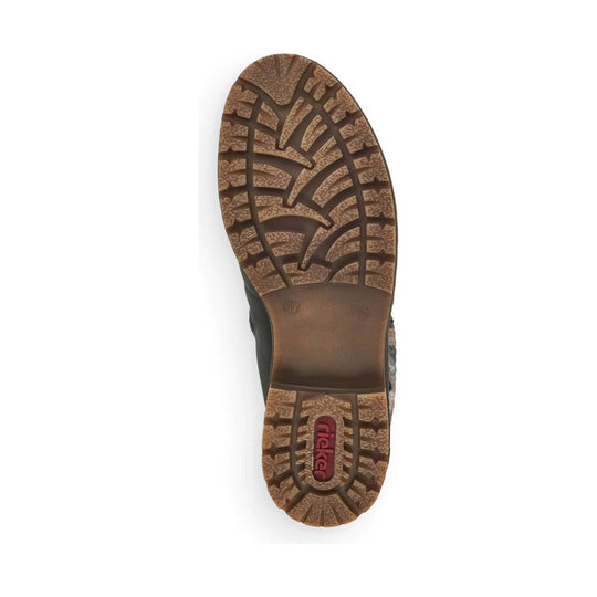 Brown lugged boot sole with deep tread and a red rieker logo at the heel
