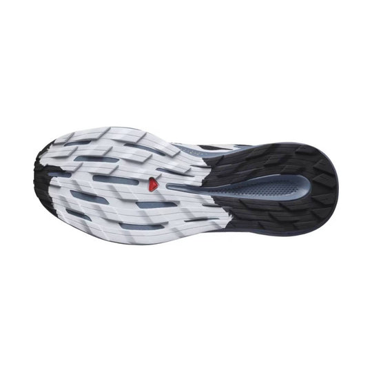 Running shoe outsole in white and black with a small red accent