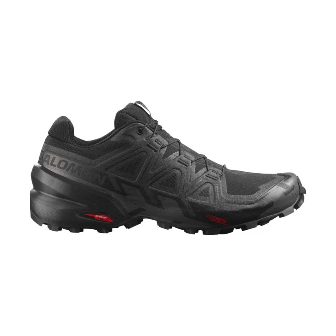 Black trail running shoe with lugged sole, quick-lace system, and red outsole accents