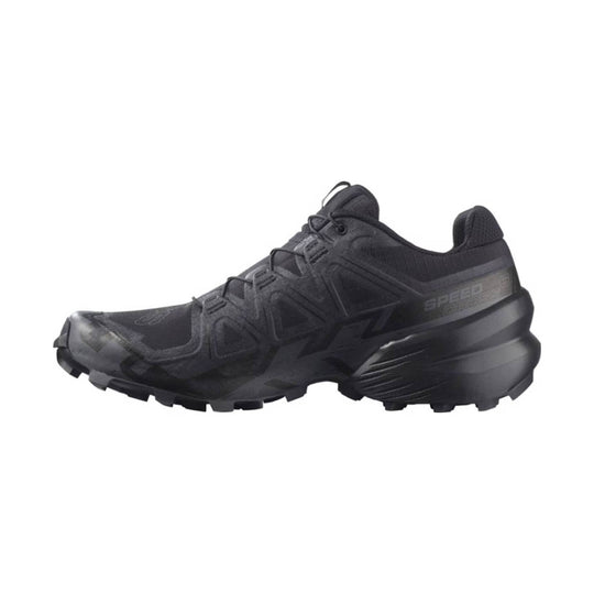 Black trail running shoe with lugged outsole, bungee laces, and side heel cushioning