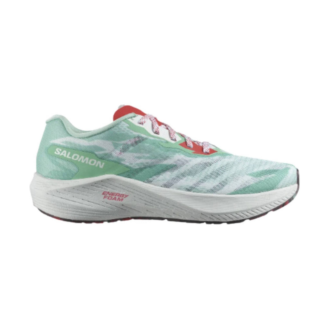 Mint green running shoe with white foam midsole, red accents, and printed side branding