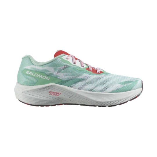 Mint green running shoe with white foam midsole, red accents, and printed side branding