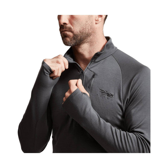 Dark gray long-sleeve quarter-zip performance top with thumb holes and a small chest logo